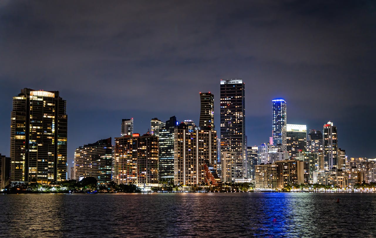Miami Brickell skyline at night over Biscayne Bay, where most preconstruction condos sell on staged deposit schedules