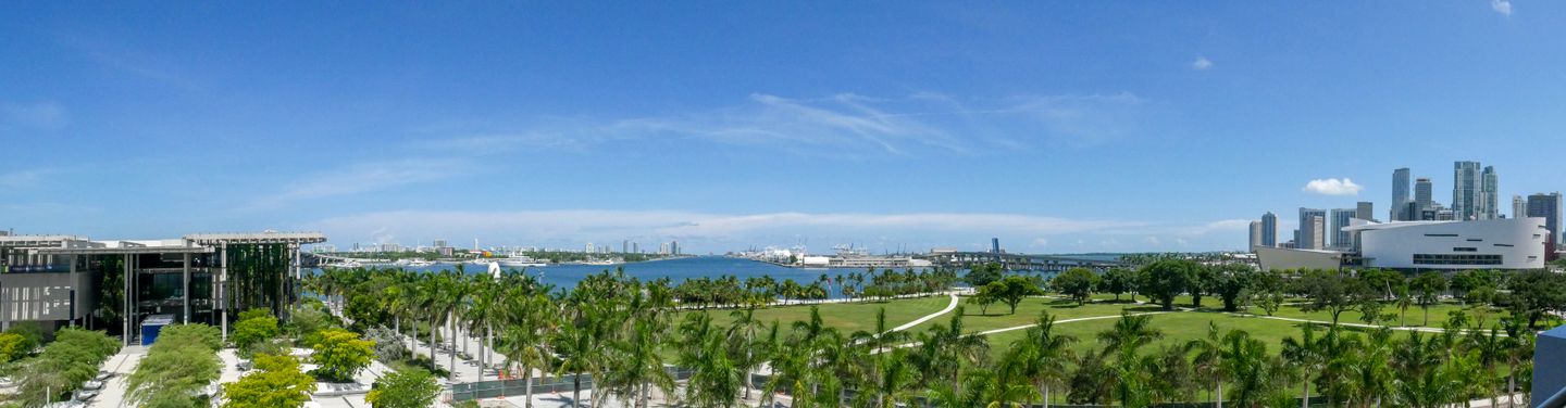 Aerial panorama of Museum Park, Biscayne Bay, and the downtown Miami skyline on a clear day