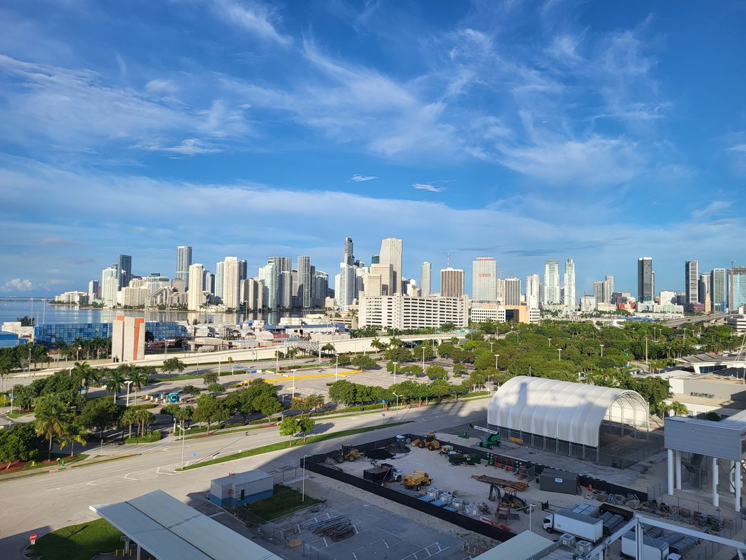 Downtown Miami and Brickell skyline of luxury condo and office towers across Biscayne Bay under a clear sky