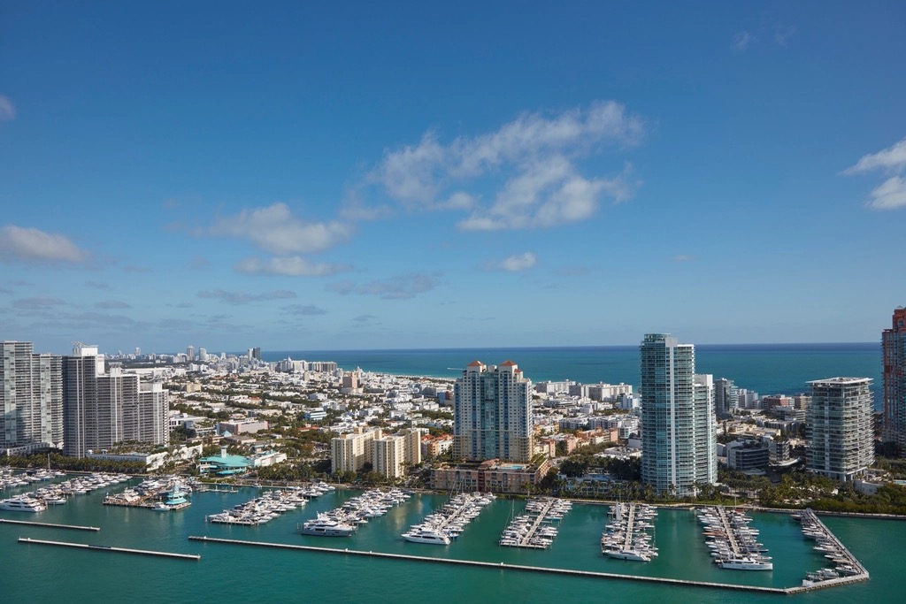 Aerial view of South Beach condominium towers and a full marina looking east over Biscayne Bay