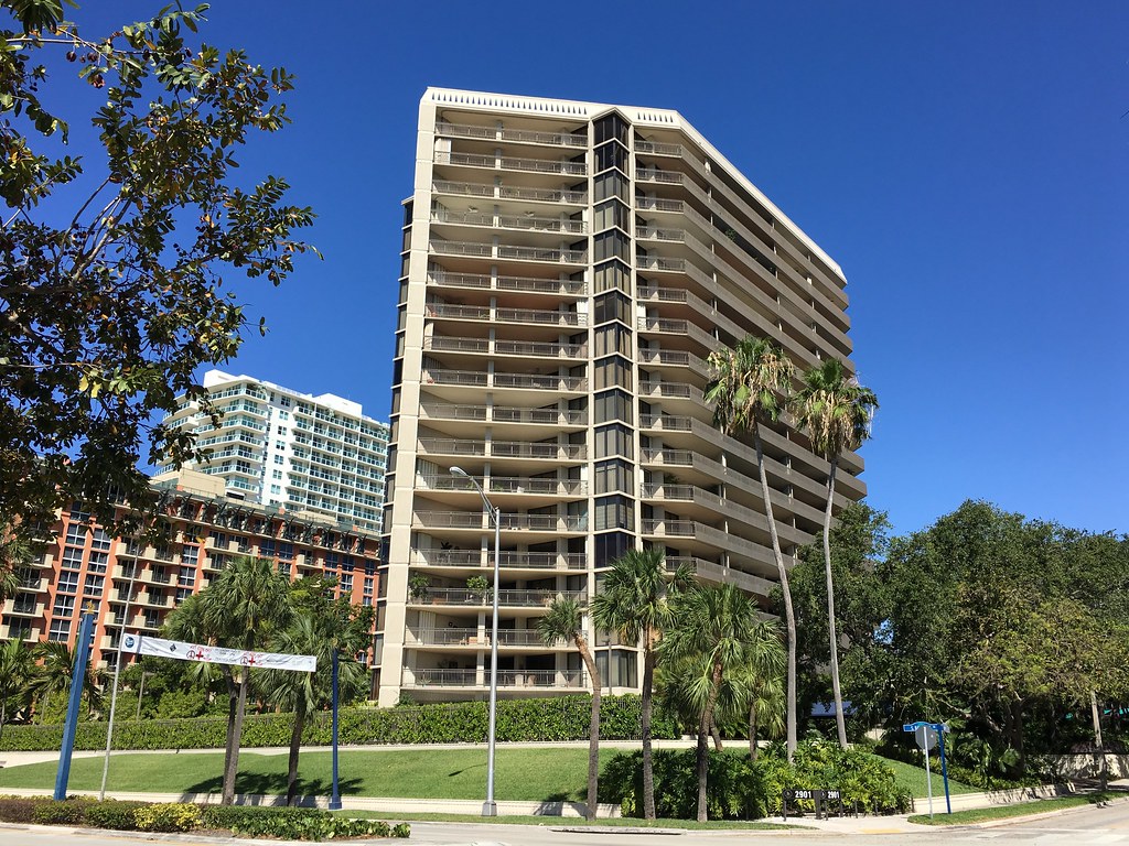 Waterfront condominium tower surrounded by palms in Coconut Grove, Miami