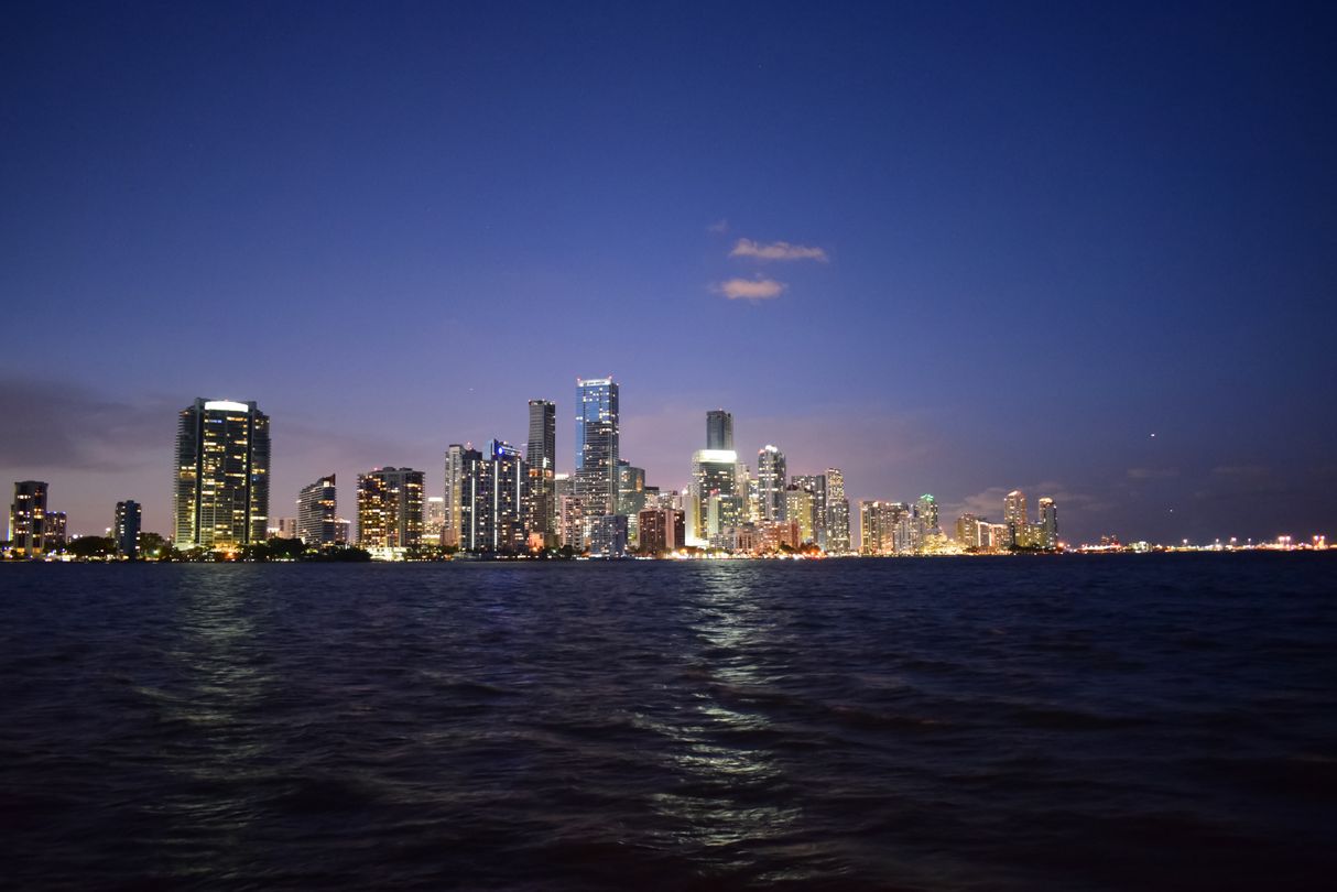 Brickell and downtown Miami new construction condo skyline at dusk over Biscayne Bay
